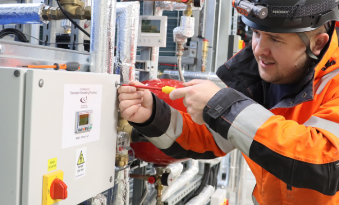 an engineer commissioning a rainwater harvesting system in a large warehouse