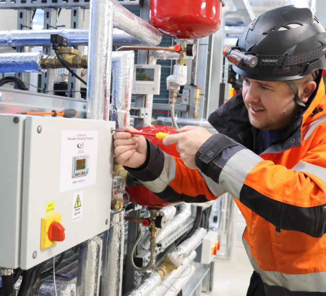 an engineer commissioning a rainwater harvesting system in a large warehouse